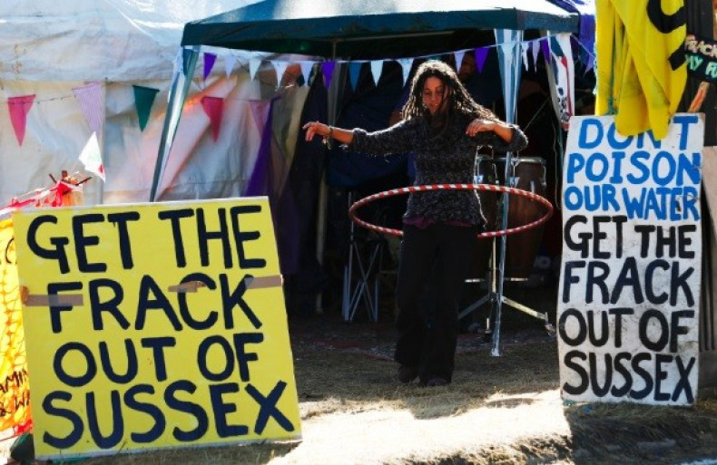 A demonstrator hula hoops among banners in the protest camp by the entrance to a site run by Cuadrilla Resources, outside the village of Balcombe in southern England (Photo: Reuters)