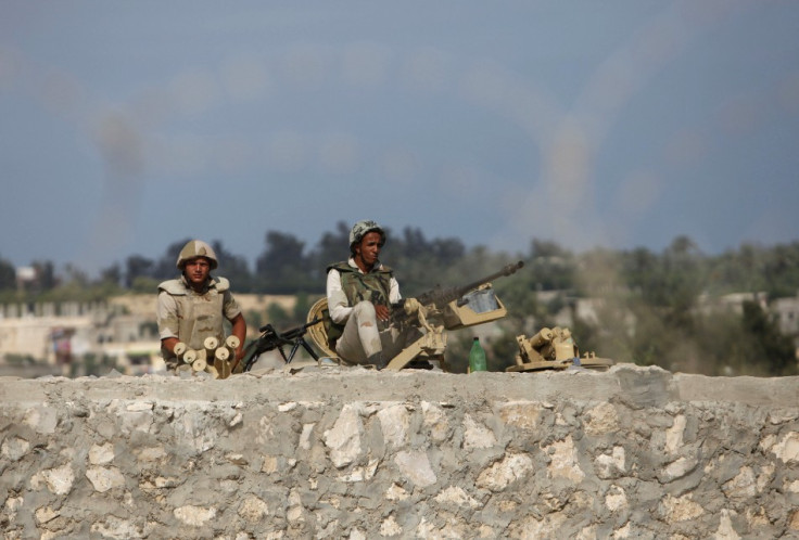 Egyptian soldiers keep guard on the border between Egypt and southern Gaza Strip