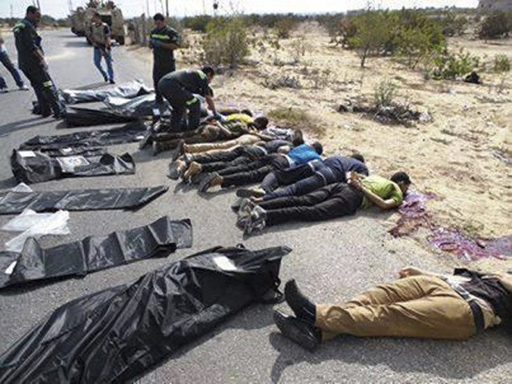 Army soldiers and medical workers check the bodies of police officers killed early morning on the highway in Rafah city