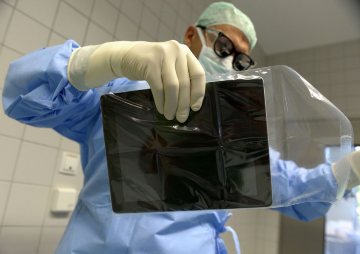 Professor Karl Oldhafer at the Asklepios Hospital Hamburg-Barmbek, Germany, makes sure that the iPad is kept in a sterile cover like every other instrument used in the surgery. (Photo: REUTERS/Fabian Bimmer)