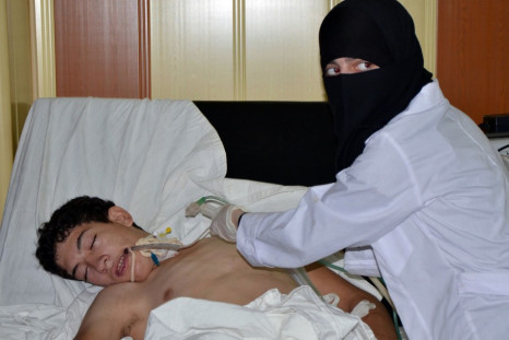 A youth, affected by what activists say is nerve gas, is treated at a hospital in the Duma neighbourhood of Damascus