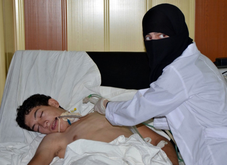 A youth, affected by what activists say is nerve gas, is treated at a hospital in the Duma neighbourhood of Damascus