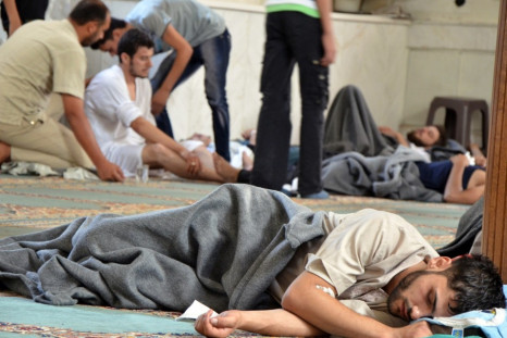 Survivors from what activists say is a gas attack rest inside a mosque in the Duma neighbourhood of Damascus