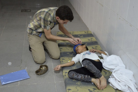 A boy, affected by what activists say was a gas attack, is treated at a medical center in the Damascus suburbs of Saqba,