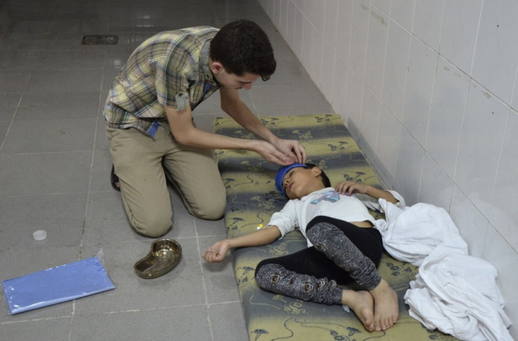 A boy, affected by what activists say was a gas attack, is treated at a medical center in the Damascus suburbs of Saqba,