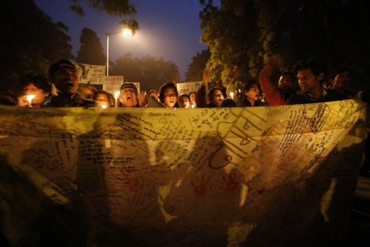 Demonstrators hold a banner with their signatures during a candlelight march for a gang rape victim, who was assaulted in New Delhi January 16, 2013. A 23-year-old physiotherapy student was raped and beaten in Delhi on December 16, prompting millions of I