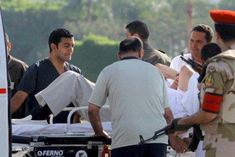 Mubarak helped into an ambulance after being flown to Maadi military hospital