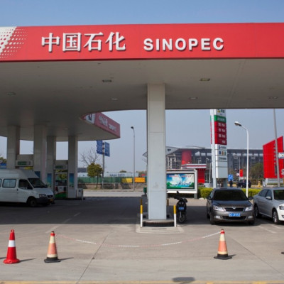 Cars are seen parked at a Sinopec gas station in Shanghai