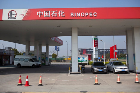 Cars are seen parked at a Sinopec gas station in Shanghai