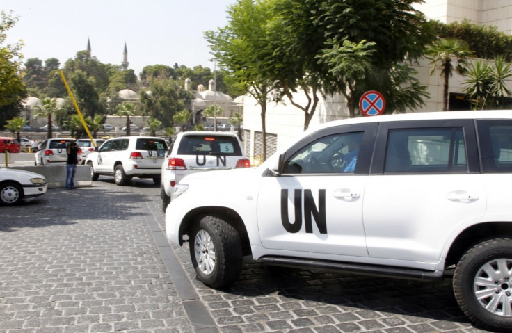 United Nations (U.N.) vehicles transport a team of U.N. chemical weapons experts to the scene of a poison gas attack outside the Syrian capital last week