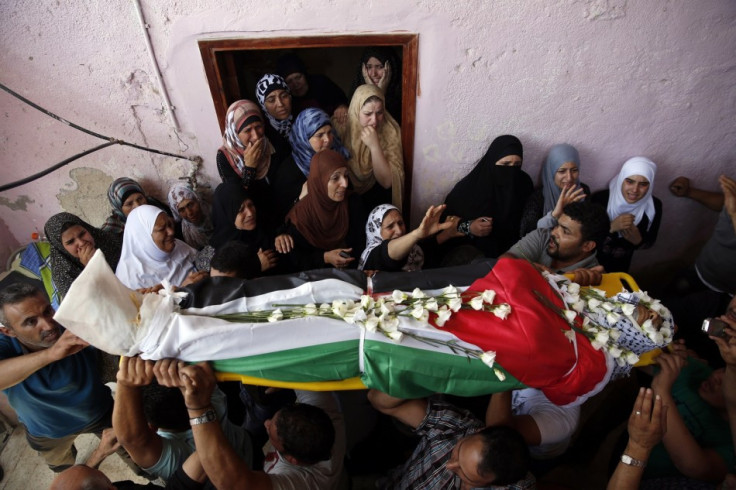 Palestinians carry the body of Jihad Aslan during his funeral at Qalandiya Refugee Camp near the West Bank city of Ramallah