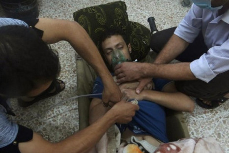 An emergency response team attends to a chemical attack victim in Syria