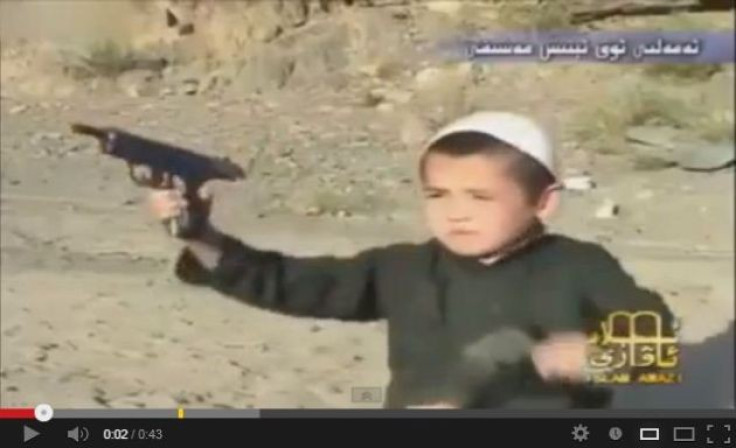 Screenshot of a video shows a boy firing guns from a pistol at Al-Qaida's terrorist camp in Afghanistan. (YouTube)