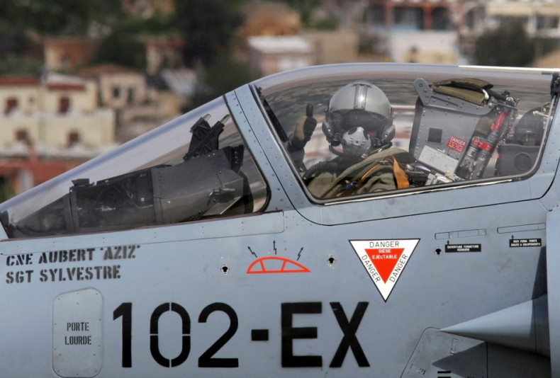 A French pilot gives a thumbs-up before taking off in a French Mirage 2000 fighter jet from the Greek air base at Souda