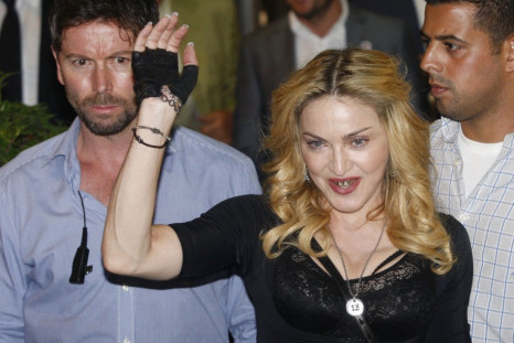 US singer Madonna waves as she leaves the new Hard Candy Fitness centre in downtown Rome August 21, 2013. Madonna is the top-earning celebrity in the world. (REUTERS/Remo Casilli)