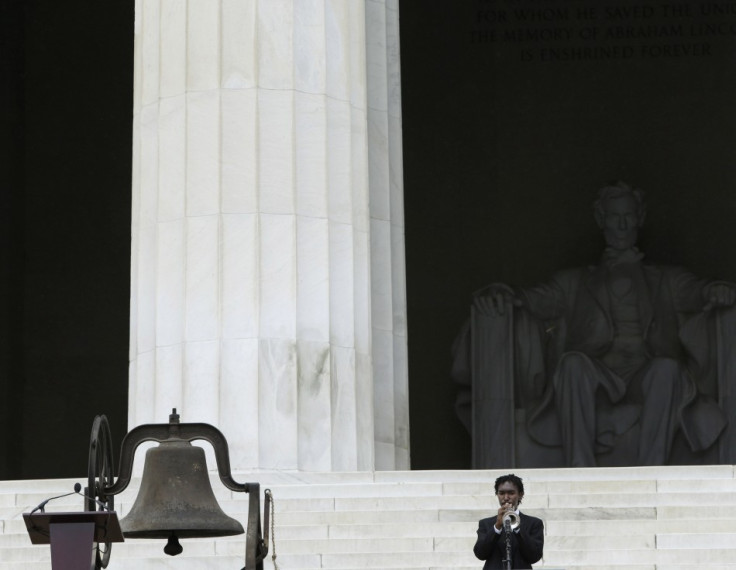 A young man plays "When the Saints Go Marching In" on his trumpet to start 50th anniversary ceremonies of the 1963 "March on Washington" at the Lincoln Memorial in Washington