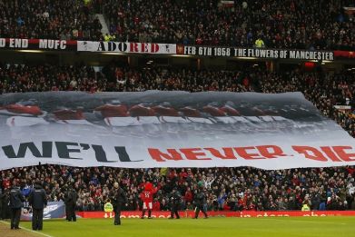 A banner is unfurled at Old Trafford to commemorate the 55th anniversary of the Munich air crash (Reuters)