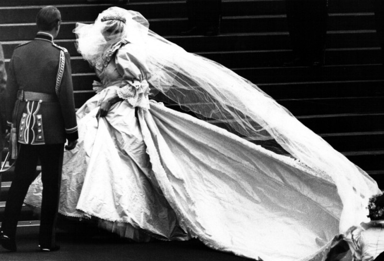 This iconic photo shows Lady Diana Spencer, soon to become the Princess of Wales, showing her wedding gown for the first time, turns as her bridesmaids set her train on arrival at Saint Paul's Cathedral for her wedding to Prince Charles in London, July 2