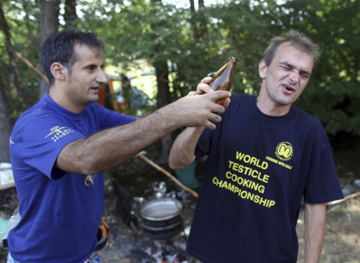 Testicle eaters use alcohol to wash out their mouths at Serbia's Testicle Cooking Championships PIC: Reuter