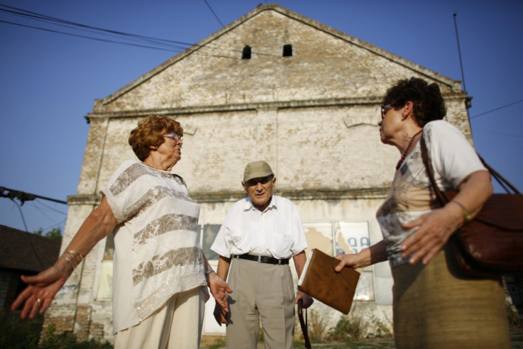Lucija Rajner (L), Marijana Sibinovic (R) and Teodor Kovac talk on the site where their fathers were interned in Topovske Supe, a WWII-era Nazi concentration camp for Jews in Serbia's capital Belgrade