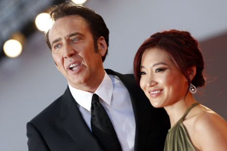 Actor Nicolas Cage and his wife Alice Kim pose during a red carpet during the 70th Venice Film Festival in Venice August 30, 2013. Cage stars in David Gordon Green's movie Joe, which debuts at the Venice Film Festival. (REUTERS/Alessandro Bianchi)