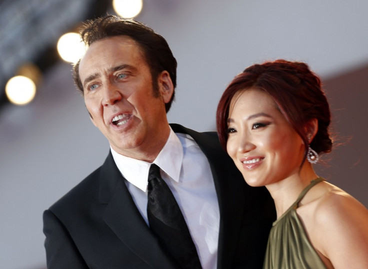 Actor Nicolas Cage and his wife Alice Kim pose during a red carpet during the 70th Venice Film Festival in Venice August 30, 2013. Cage stars in David Gordon Green's movie Joe, which debuts at the Venice Film Festival. (REUTERS/Alessandro Bianchi)