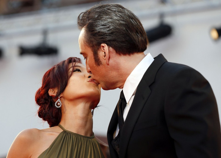 Cage kisses his wife Alice Kim on a red carpet during the 70th Venice Film Festival. (Reuters)