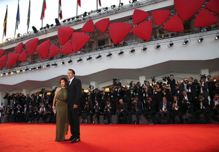 Actor Nicolas Cage and his wife Alice Kim pose on the red carpet during the 70th Venice Film Festival in Venice. Cage and Kim wedded in 2004. (Reuters)