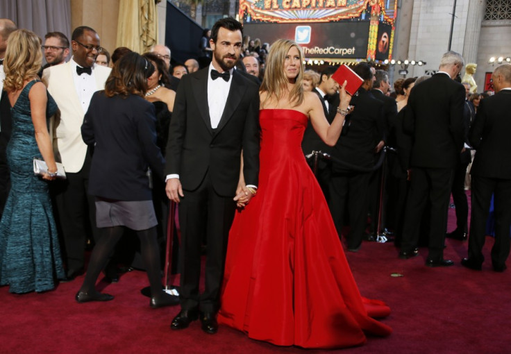 Hollywood stars Justin Theroux arrives with fiance Jennifer Aniston, who is holding a Salvatore Ferragamo clutch at the 85th Academy Awards in Hollywood. (Reuters)