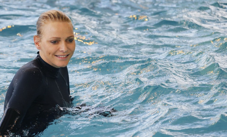 Princess Charlene looked ecstatic as she reunited with her passion for swimming.  (REUTERS/Regis Duvignau)