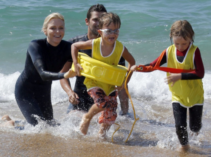 The former Olympic swimmer smiles for the shutterbugs during her swimming event for charity. (REUTERS/Regis Duvignau)