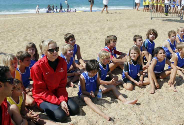 Princess Charlene of Monaco speaks with children during the event for her foundation in Capbreton, Southwestern France, September 1, 2013. (REUTERS/Regis Duvignau)