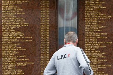 A Liverpool supporter looks at the names engraved on the Hillsborough memorial outside the club's Anfield stadium (Reuters)