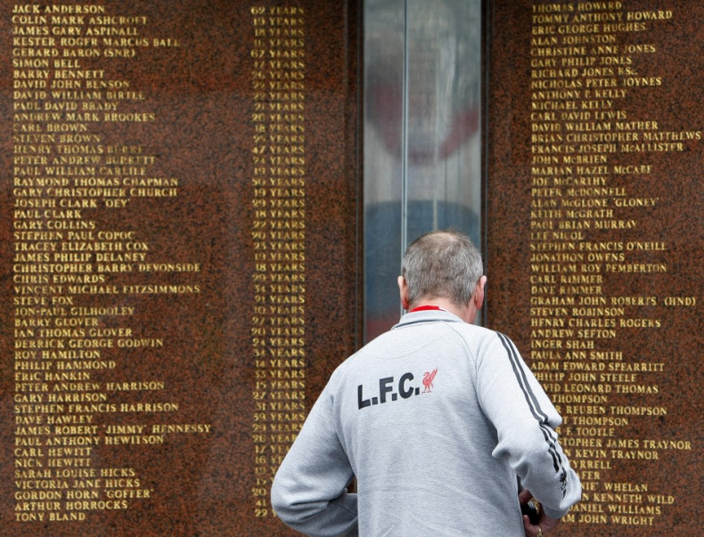 A Liverpool supporter looks at the names engraved on the Hillsborough memorial outside the club's Anfield stadium (Reuters)