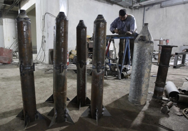 A member of the "Free Men of Syria" (Ahrar Suriya) brigade, operating under the Free Syrian Army, works to make improvised weapons as homemade rockets