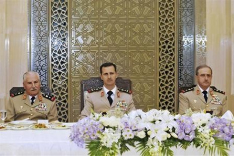 Syria's President Bashar al-Assad (C) with defence minister Gen Ali Habib (Reuters)