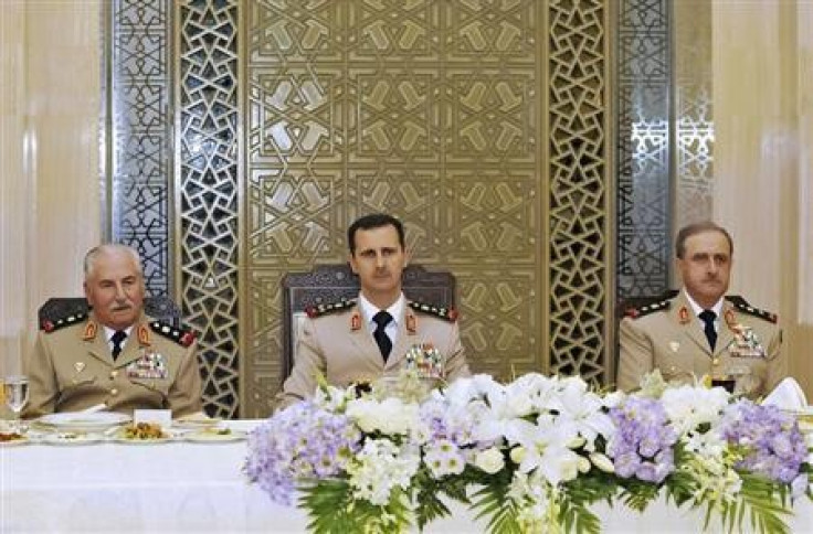 Syria's President Bashar al-Assad (C) with defence minister Gen Ali Habib (Reuters)