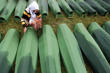 A Bosnian woman cries beside the coffin of a relative, which is one of the 409 coffins of newly identified victims from the 1995 Srebrenica massacre