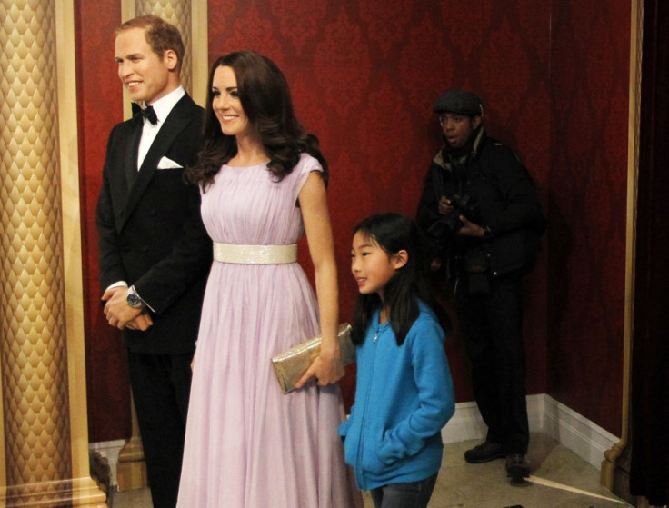 Visitors pose with wax models of Britain's Royal couple William and Catherine, the Duke and Duchess of Cambridge, at Madame Tussauds in New York, April 4, 2012. (REUTERS/Brendan McDermid)