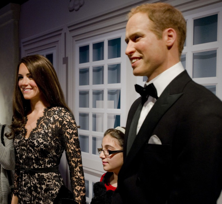 Visitors pose with waxwork models of royal couple at Madame Tussauds in Amsterdam April 4, 2012. (Reuters)