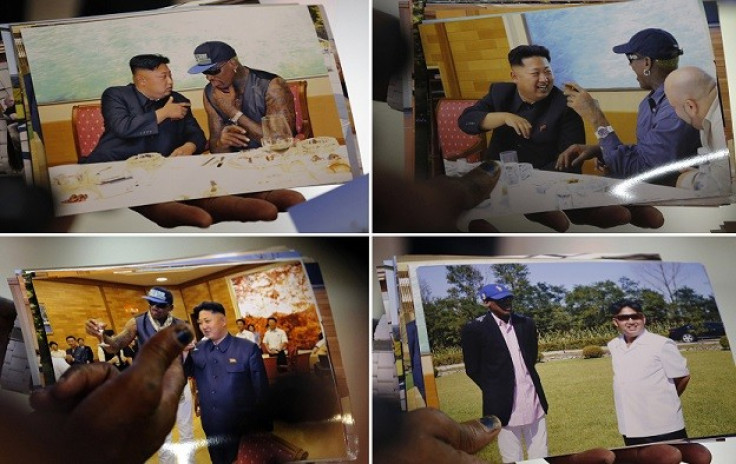 Dennis Rodman shows pictures he took with North Korean leader Kim Jong-un to the media (Reuters)
