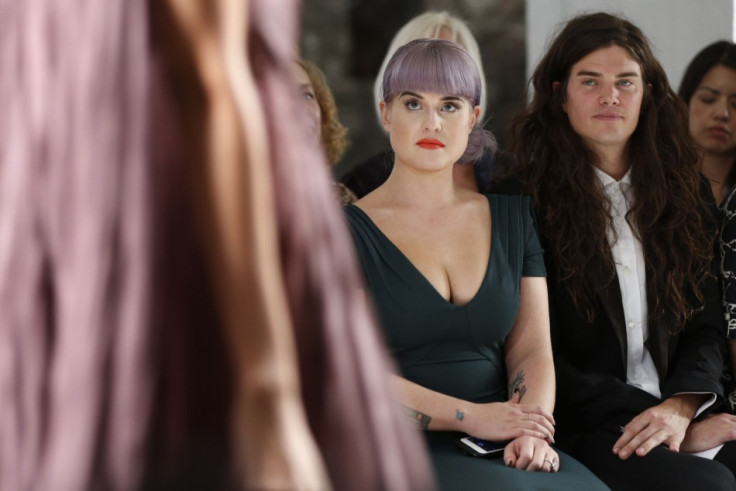 Actress Kelly Osbourne and her fiance Matthew Mosshart (R) watch models present creations from Zac Posen's Spring/Summer 2014 collection during New York Fashion Week, September 8, 2013. (REUTERS/Lucas Jackson)