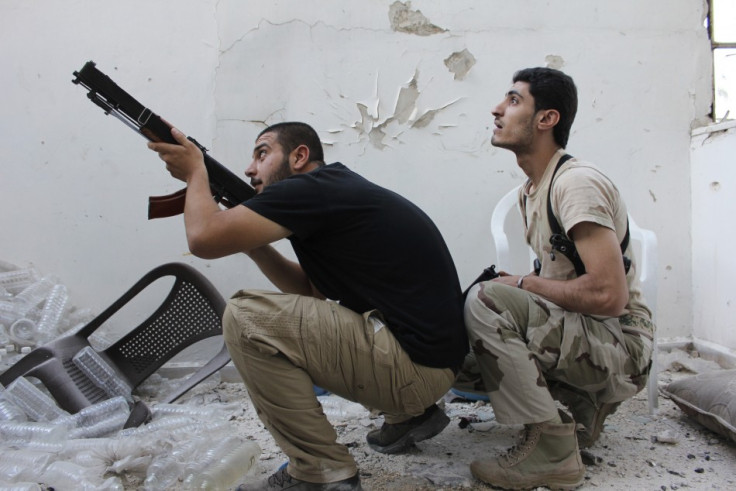 A Free Syrian Army fighter points his weapon