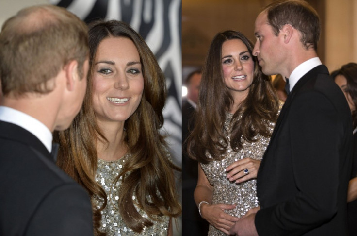 Kate shows off her engagement ring as she chats with Prince William. (Reuters)