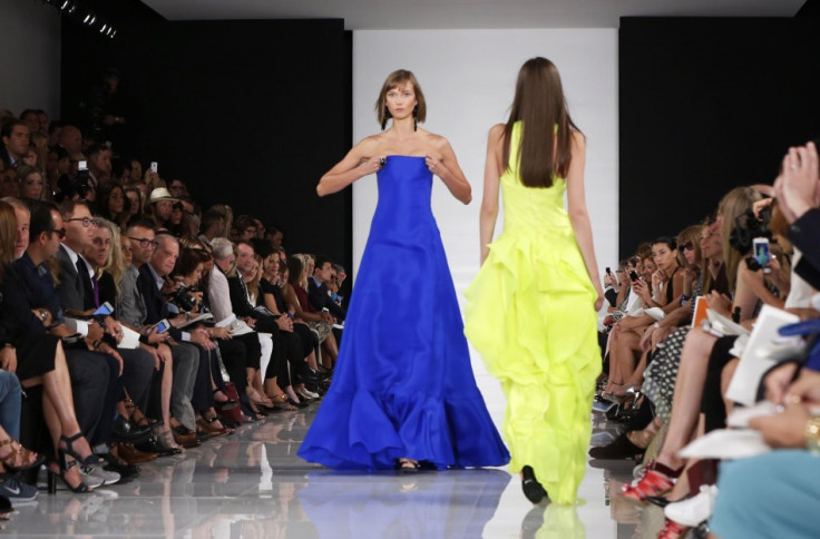 Model Karlie Kloss (L) adjusts her dress as she presents a creation from the Ralph Lauren Spring/Summer 2014 collection. (REUTERS/Lucas Jackson)