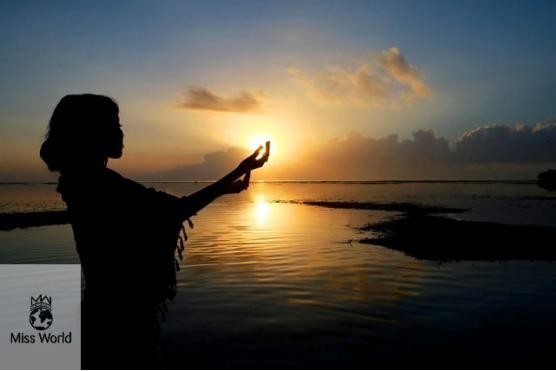 A contestant silhouetted against the Bali sunrise before releasing baby turtles into the wild.
