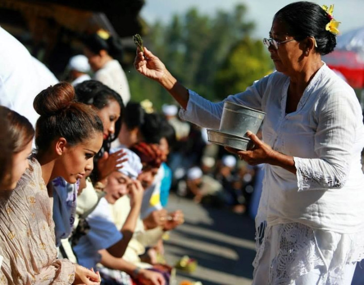 Miss World Gibraltar receives holy water from a priestess at the temple.  (Photo: Miss World/Facebook)