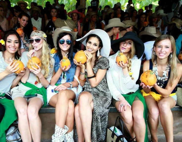 Miss World contestants enjoy a sip of coconut water at Bali Safari and Marine Park (Photo: Miss World Organisation)