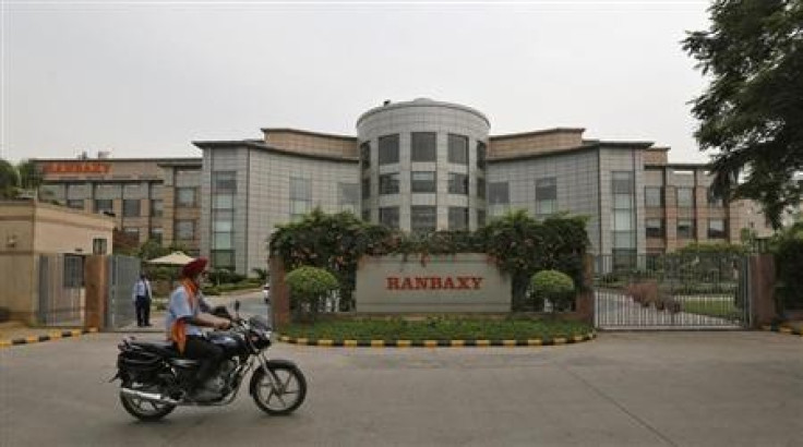A man rides a motorcycle in front of the office of Ranbaxy Laboratories at Gurgaon, on the outskirts of New Delhi, June 13, 2013.