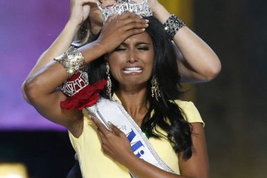 Miss America contestant, Miss New York Nina Davuluri reacts after being chosen winner of the 2014 Miss America Pageant as 2013 Miss America Mallory Hagan places a tiara on her head in Atlantic City, New Jersey, September 15, 2013. (REUTERS/Lucas Jackson)